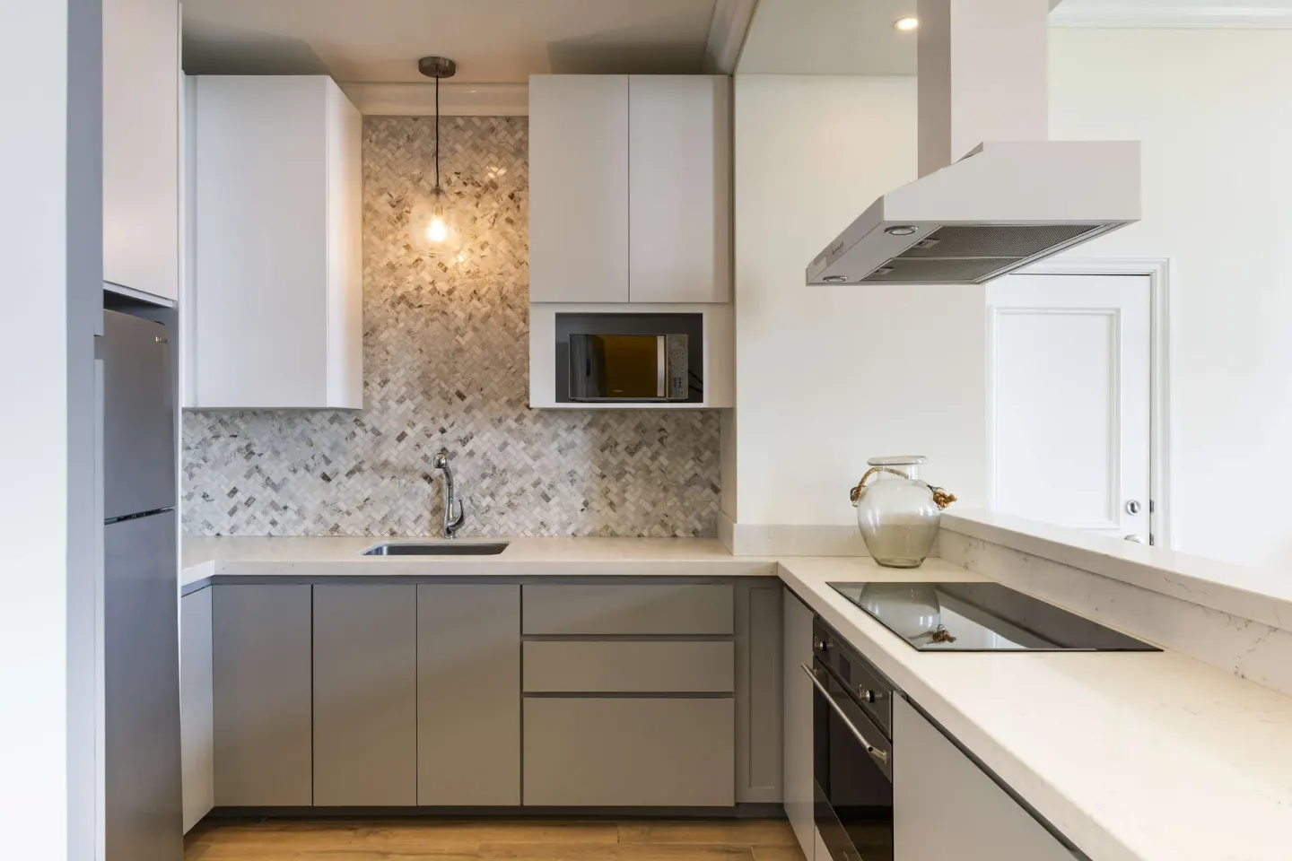 Premium suite kitchen with sink, microwave and cooktop at Hilton Barbados Resort.
