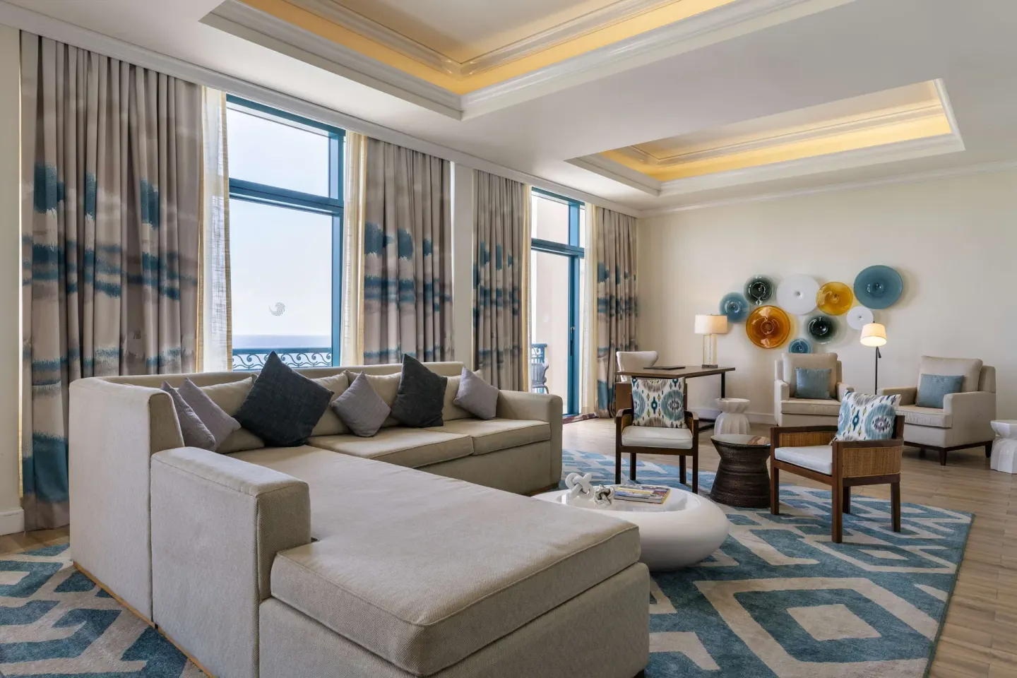 Premium suite living room with sectional sofa and ocean-facing windows at Hilton Barbados Resort.
