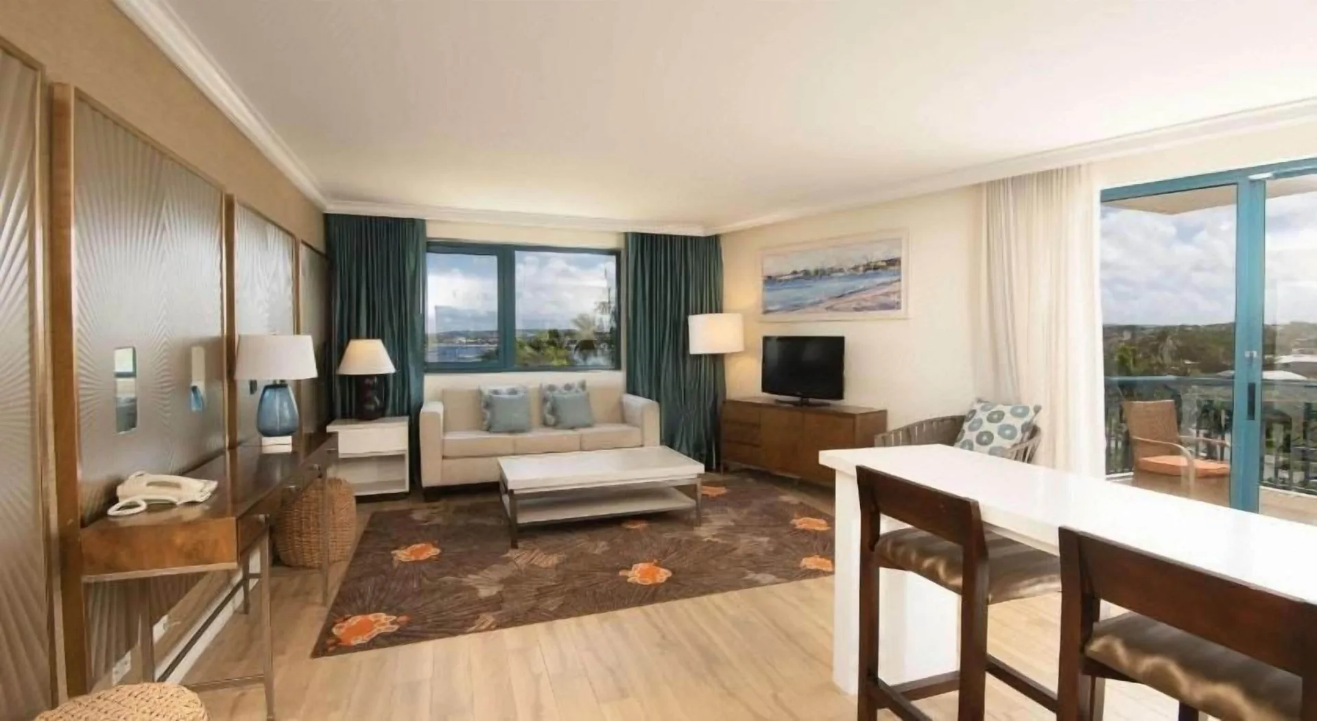 Residence 1 Bedroom Suite living room with sofa and balcony at Hilton Barbados Resort.