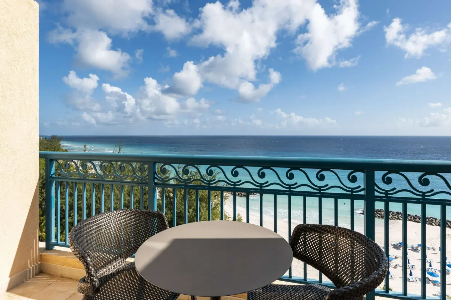 Ocean view balcony with table and chairs at Hilton Barbados Resort.