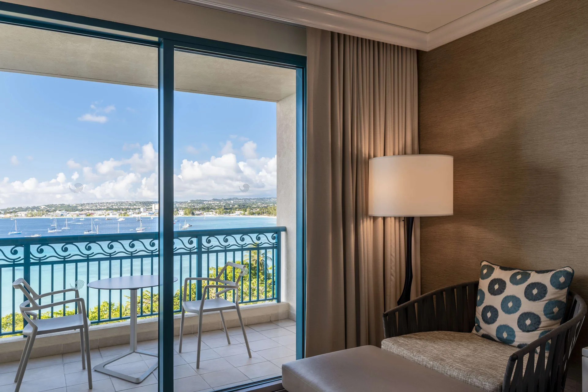 Bay View room balcony and seating area at Hilton Barbados Resort overlooking the water.