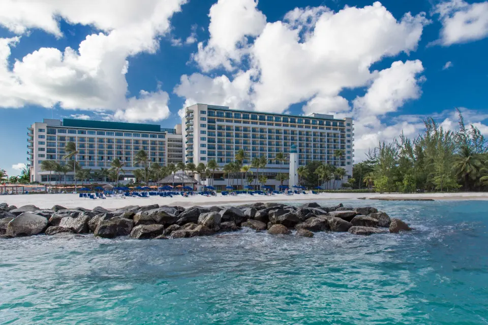 Beachfront exterior of Hilton Barbados Resort seen from the water with guest room balconies.