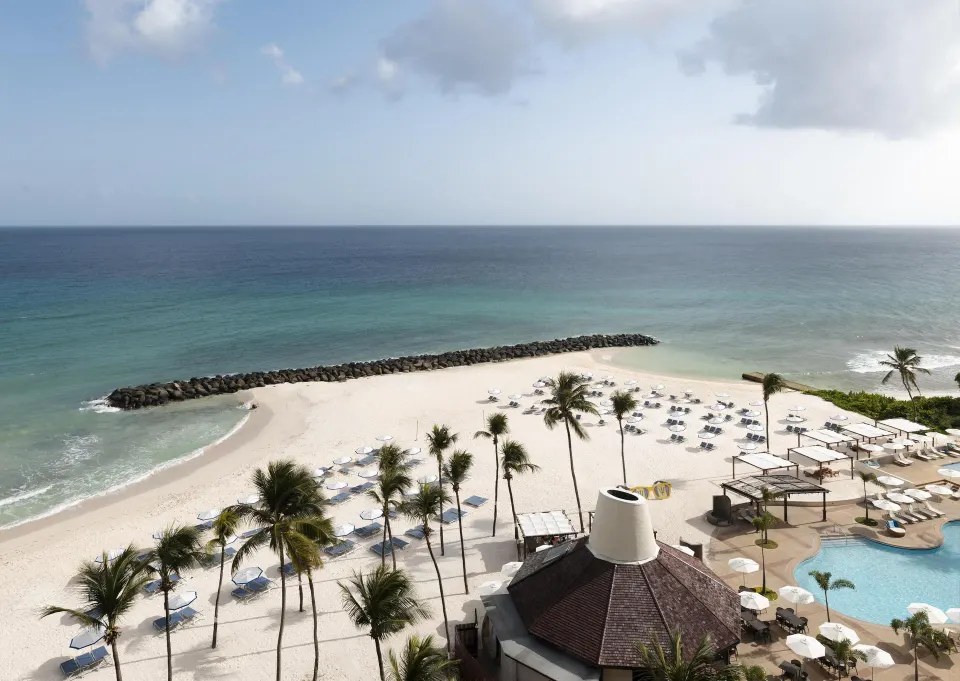 Ocean view from a corner suite overlooking the beach and pool at Hilton Barbados Resort.