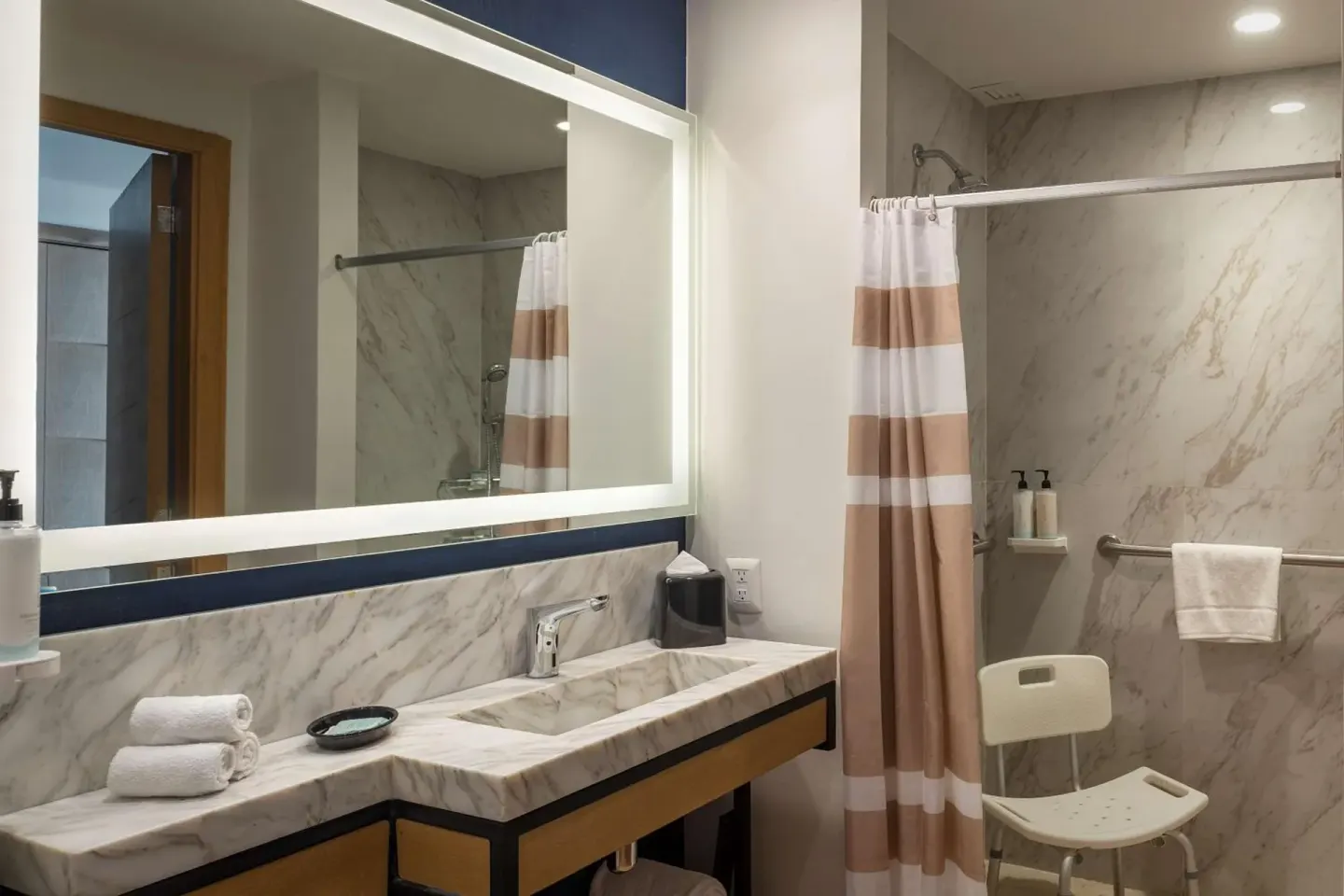 Accessible bathroom vanity and roll-in shower at Hilton Garden Inn Cancun Airport.