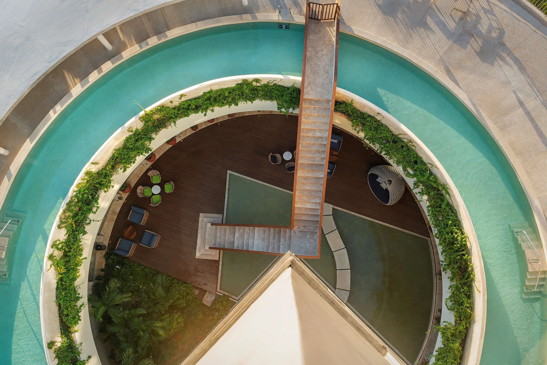 Overhead view of the circular pool and central stair at Hilton Garden Inn Cancun Airport.