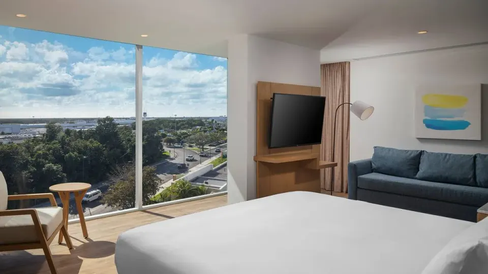 Accessible king room with roll-in shower and airport-area view at Hilton Garden Inn Cancun Airport.