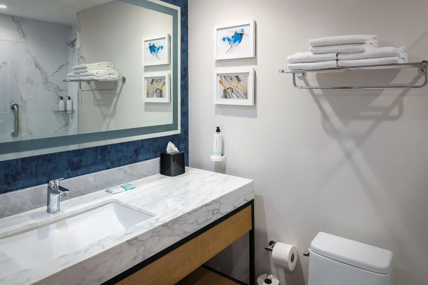 Guest bathroom vanity with towels and mirror at Hilton Garden Inn Cancun Airport.