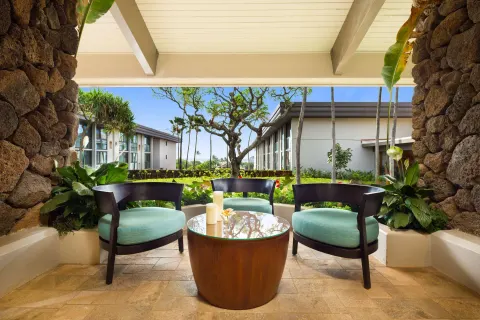 Garden-view seating nook with three chairs at Hilton Garden Inn Kauai Wailua Bay.
