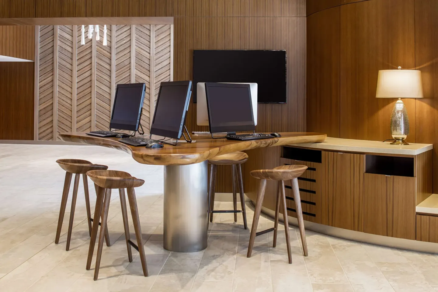 Business center computers on a wood counter at Hilton Garden Inn Waikiki Beach.
