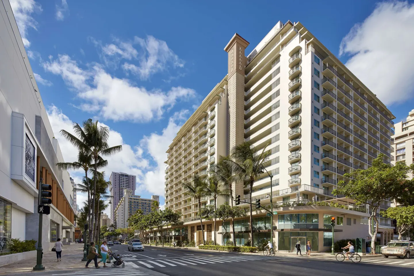 Daytime high-rise exterior and crosswalk at Hilton Garden Inn Waikiki Beach.