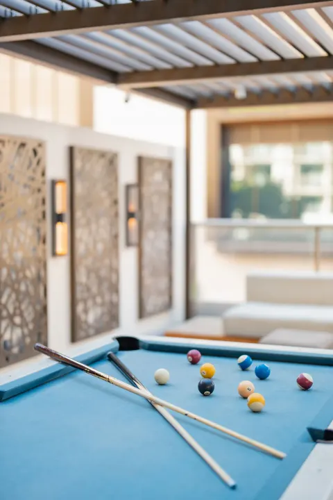 Blue-felt pool table on an outdoor terrace at Hilton Garden Inn Waikiki Beach.