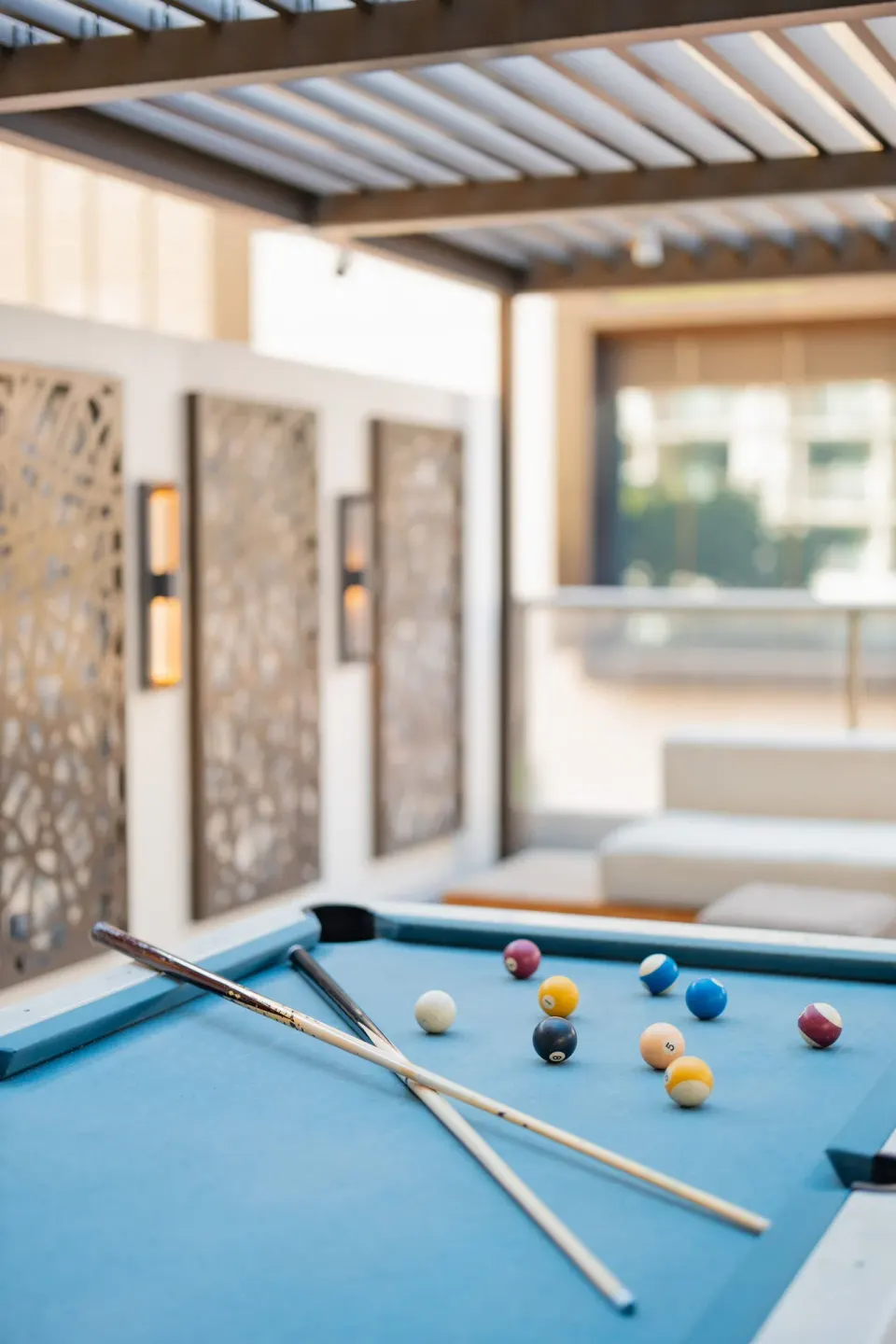 Blue-felt pool table on an outdoor terrace at Hilton Garden Inn Waikiki Beach.