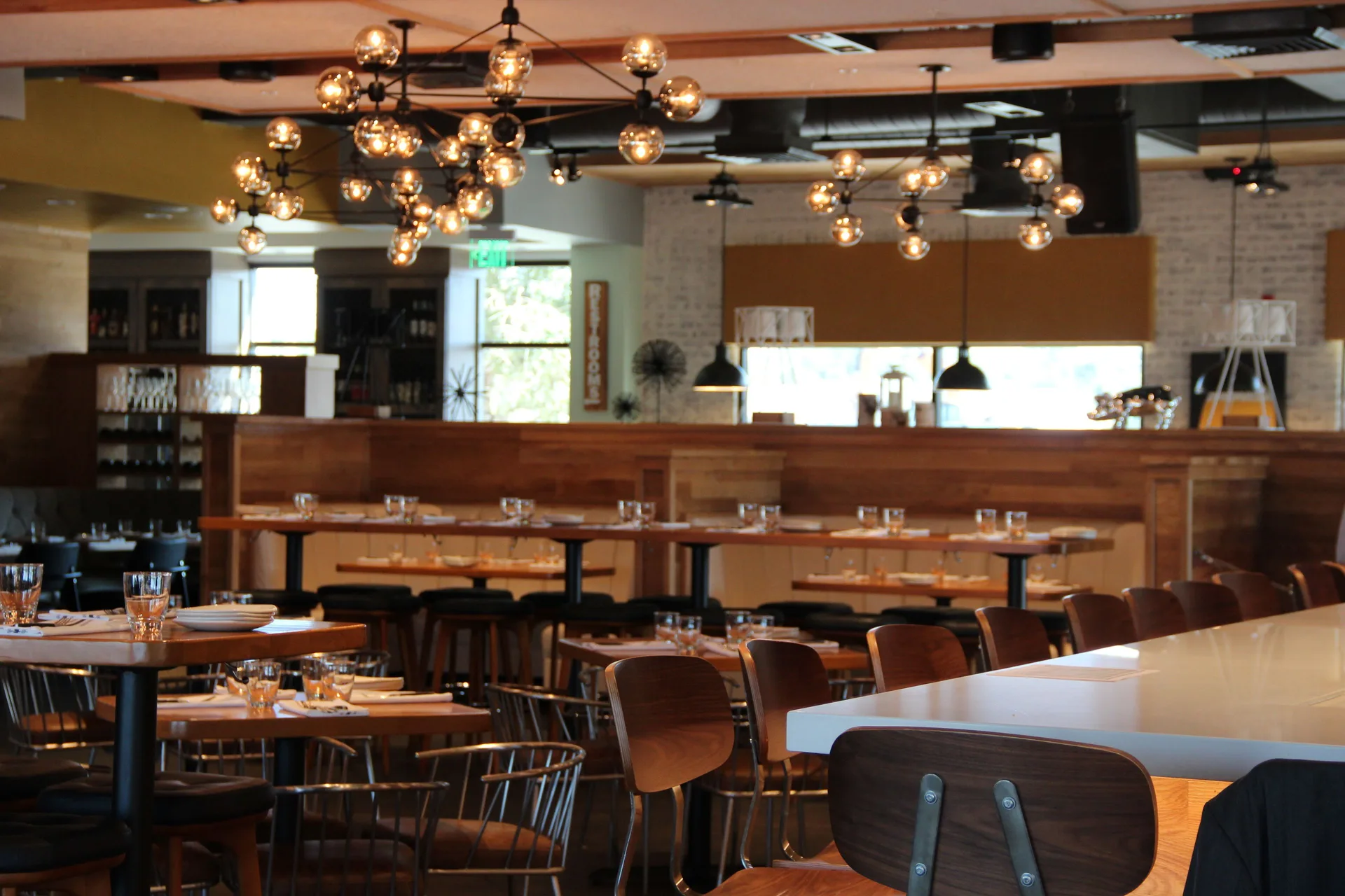 Restaurant dining room with set tables at Hilton Garden Inn Waikiki Beach.