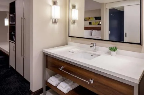 Bright vanity and mirror in a king accessible room at Hilton Garden Inn Waikiki Beach.