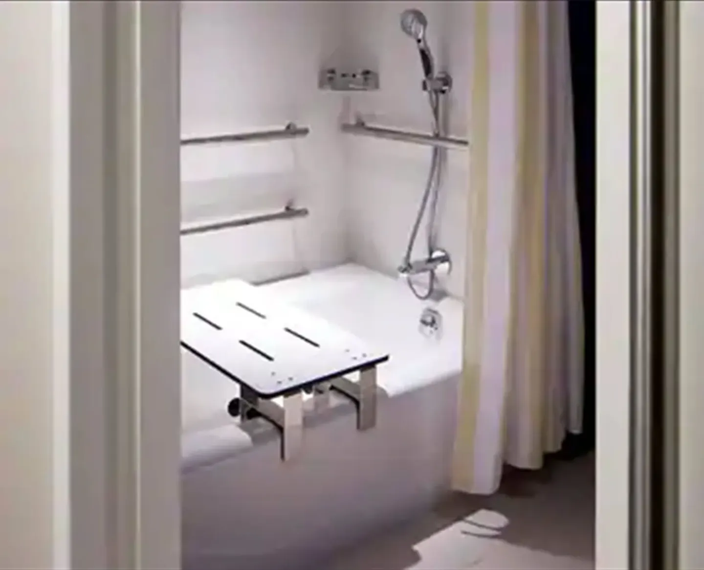 Accessible bathtub with grab bars and bath seat at Hilton Garden Inn Waikiki Beach.