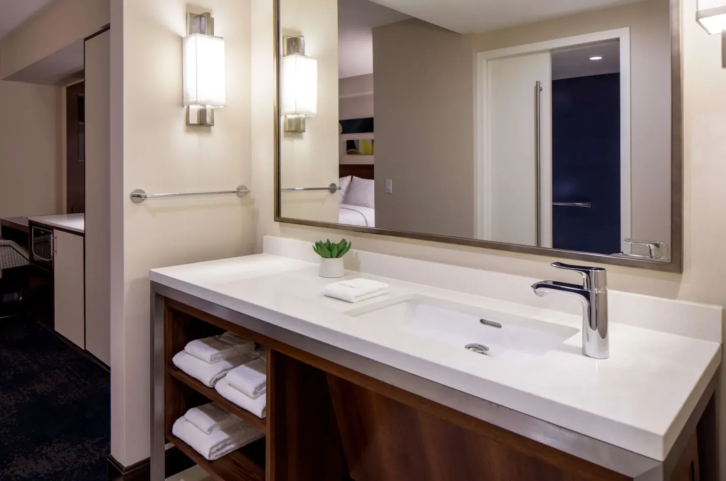 Accessible room vanity with mirror and open shelving at Hilton Garden Inn Waikiki Beach.