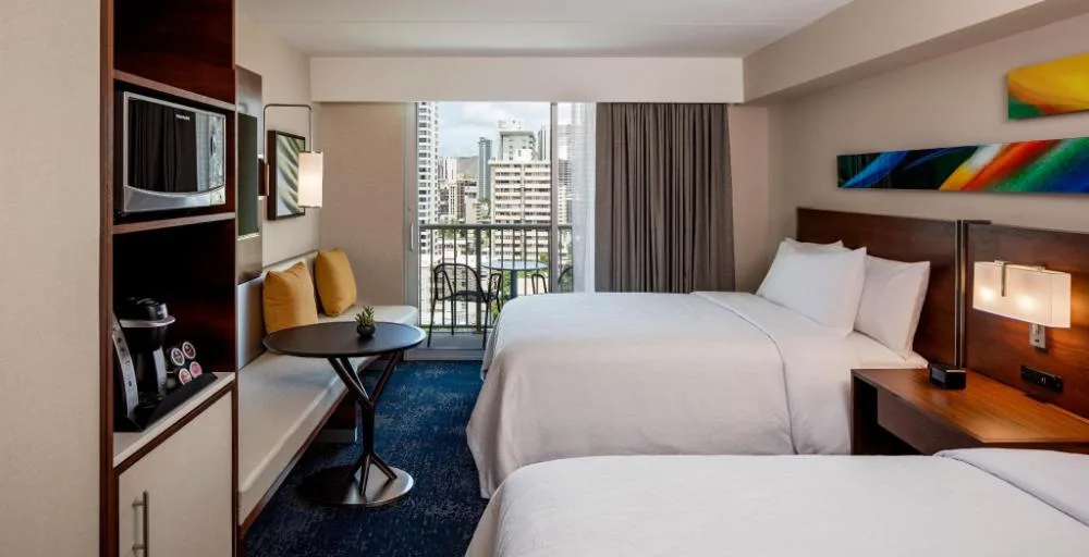 Standard low-floor room with two beds and balcony at Hilton Garden Inn Waikiki Beach.