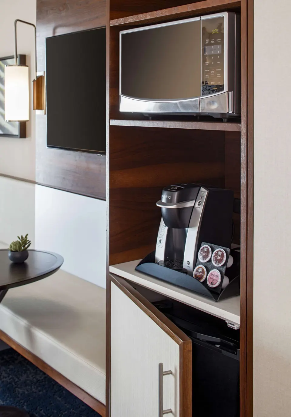 Standard Room refreshment nook with microwave, coffee maker, and mini fridge at Hilton Garden Inn Waikiki Beach.