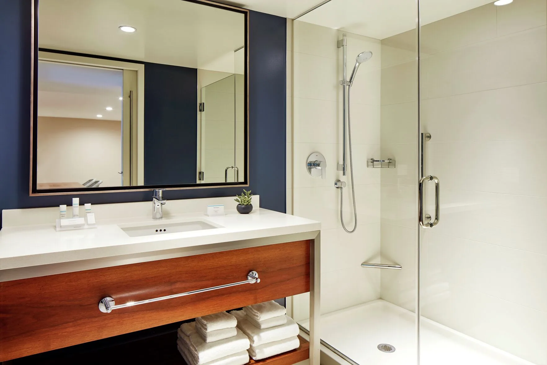 Suite 1 Bedroom City View bathroom vanity and glass shower at Hilton Garden Inn Waikiki Beach.