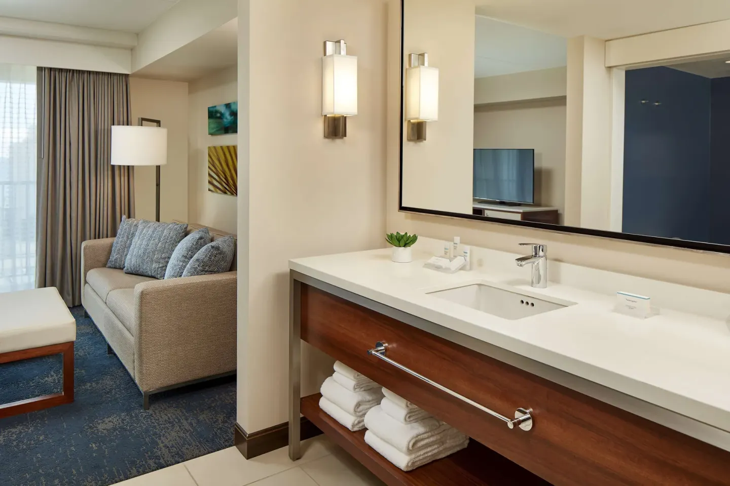 Accessible suite vanity beside the sitting area at Hilton Garden Inn Waikiki Beach.