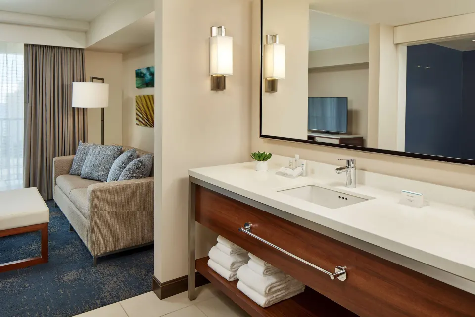Accessible suite vanity beside the sitting area at Hilton Garden Inn Waikiki Beach.