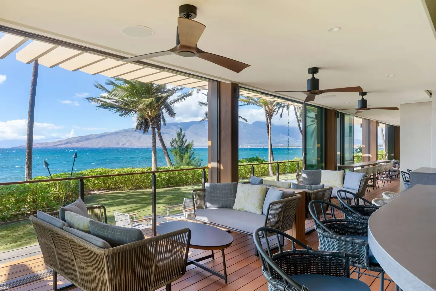 Covered oceanfront terrace seating at Hilton Grand Vacations Club Maui Bay Villas.