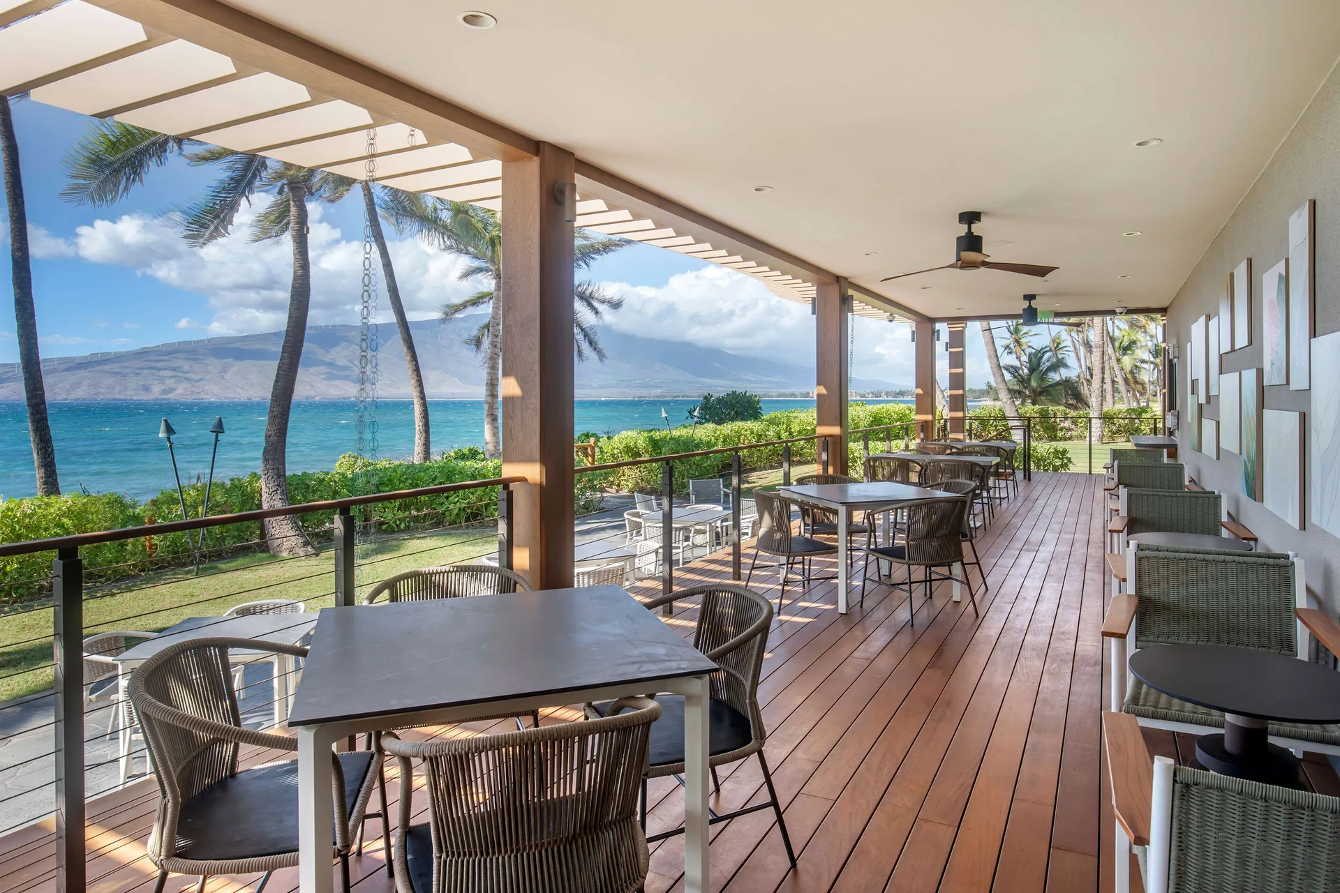 Oceanview dining terrace with tables at Hilton Grand Vacations Club Maui Bay Villas.