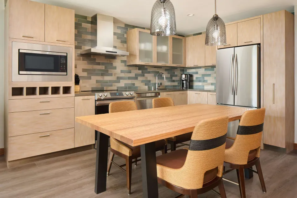 Kitchen and dining table in a resort view suite at Hilton Grand Vacations Club Maui Bay Villas.