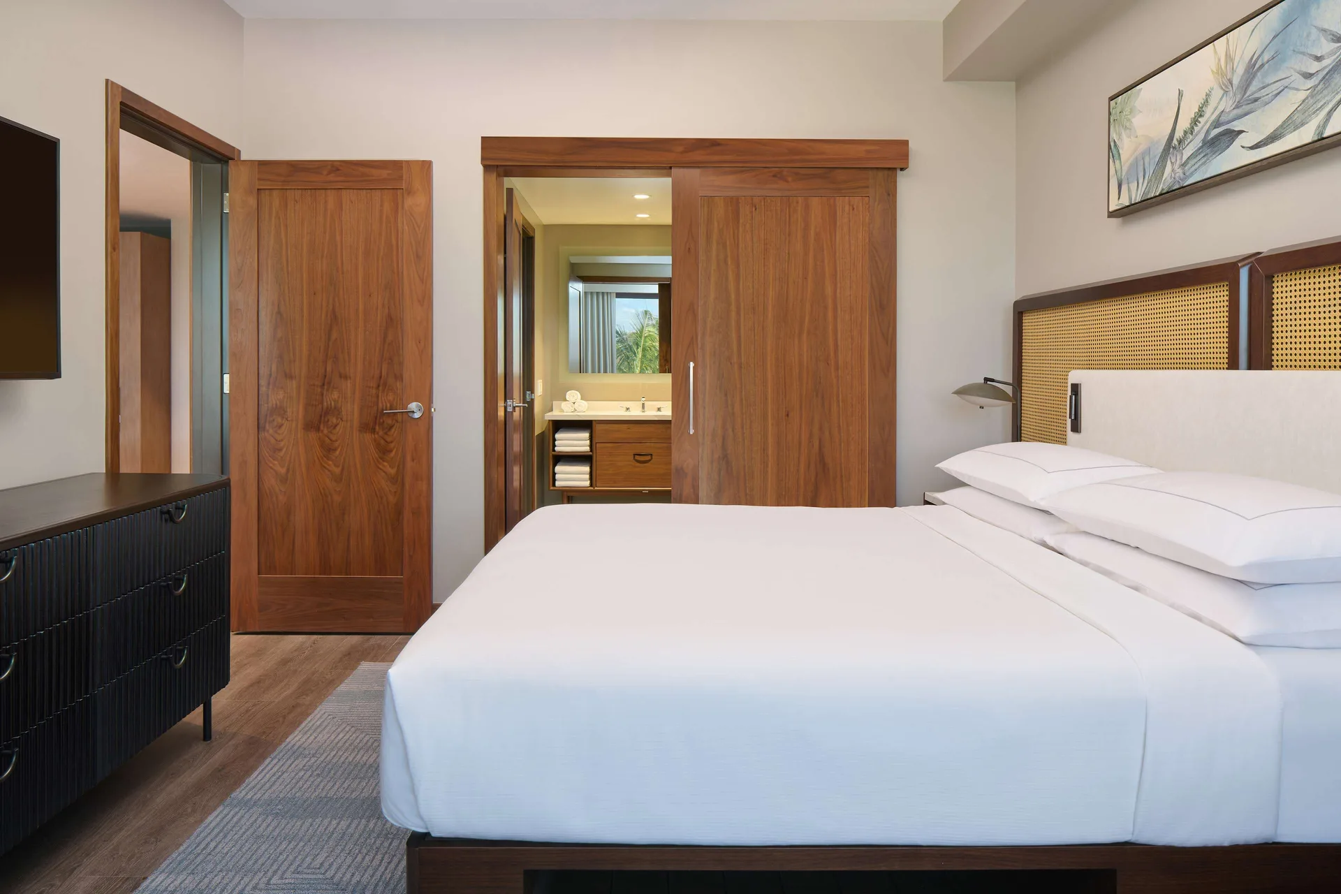 Primary bedroom with a king bed in a 2 Bedroom suite at Hilton Grand Vacations Club Maui Bay Villas.