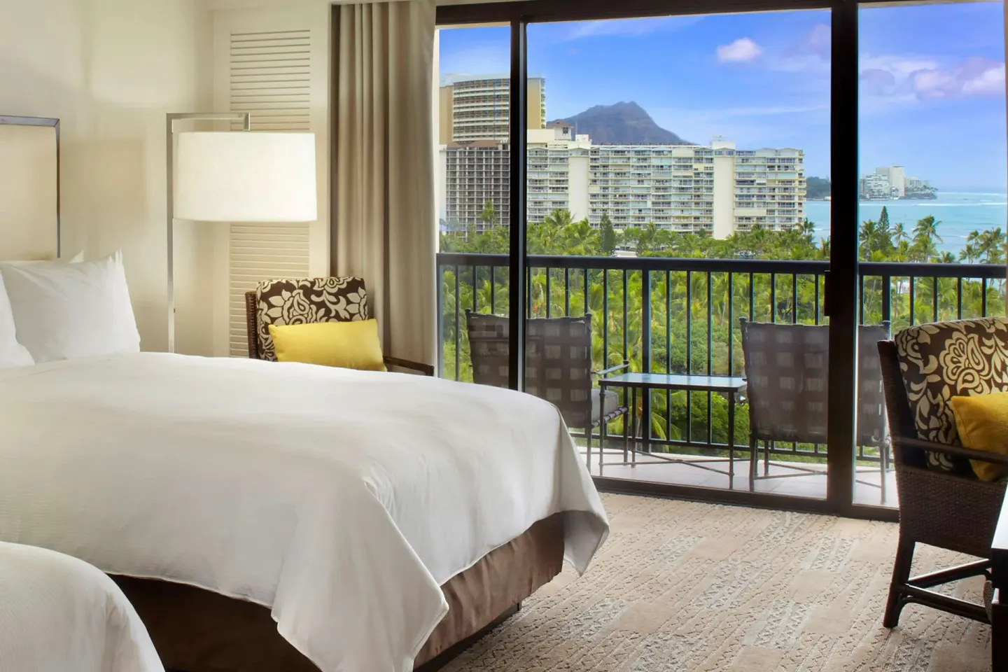 Guest room with two beds and balcony view toward Diamond Head at Hilton Hawaiian Village Waikiki Beach Resort.