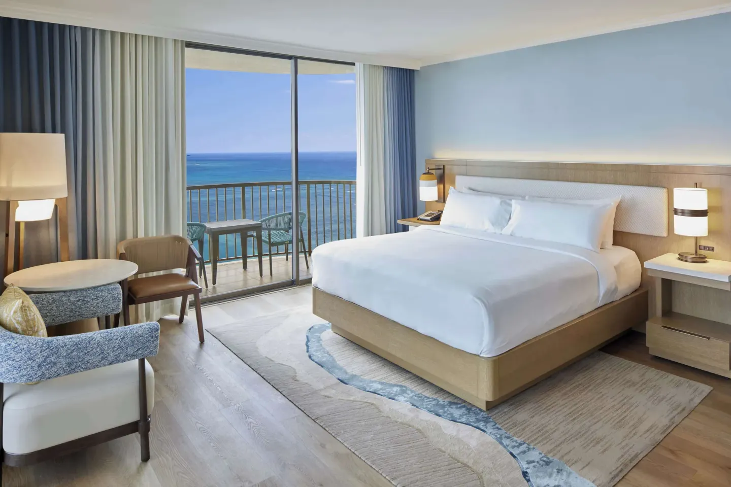 Ocean view king guest room with balcony at Hilton Hawaiian Village Waikiki Beach Resort.
