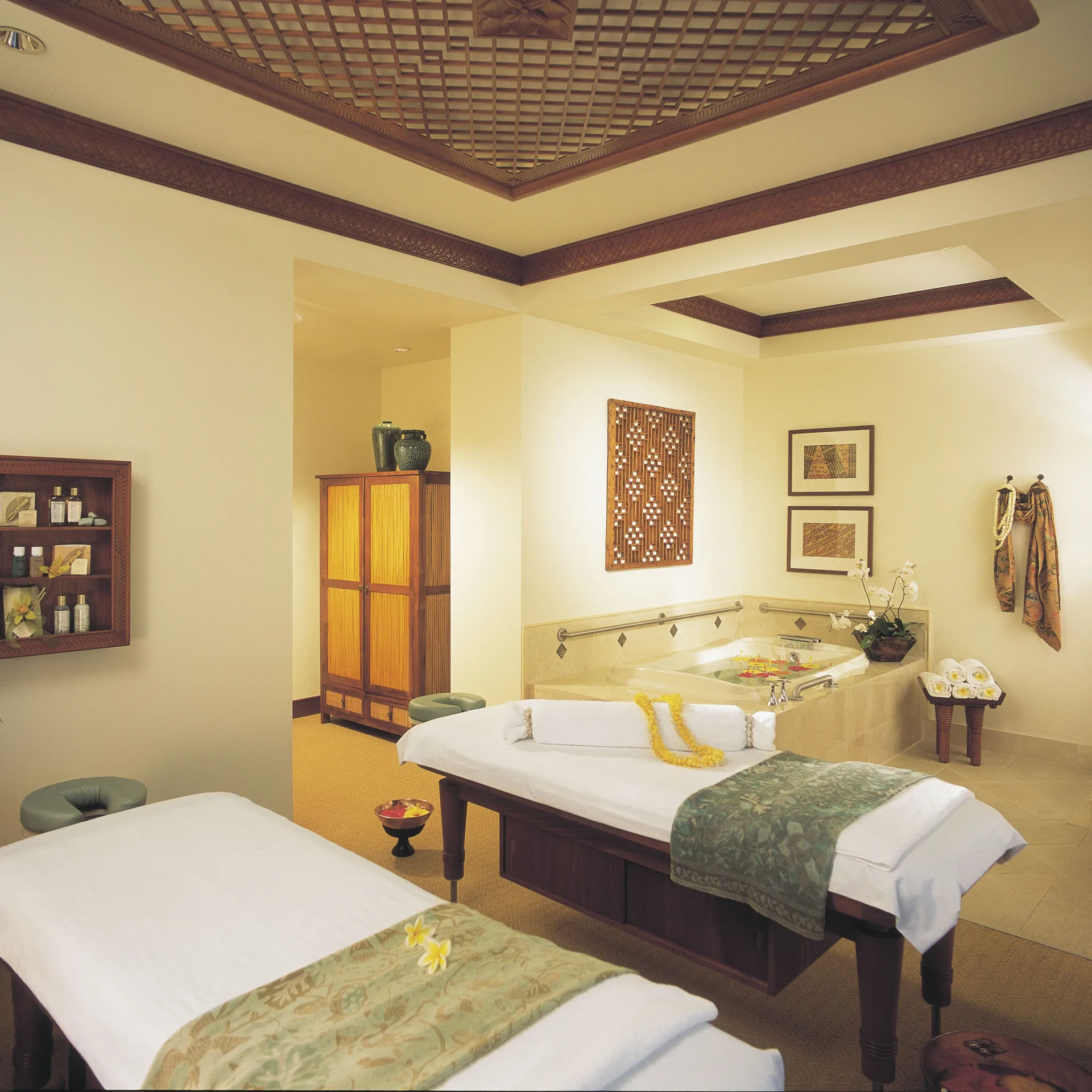 Spa treatment room with massage tables and soaking tub at Hilton Hawaiian Village Waikiki Beach Resort.