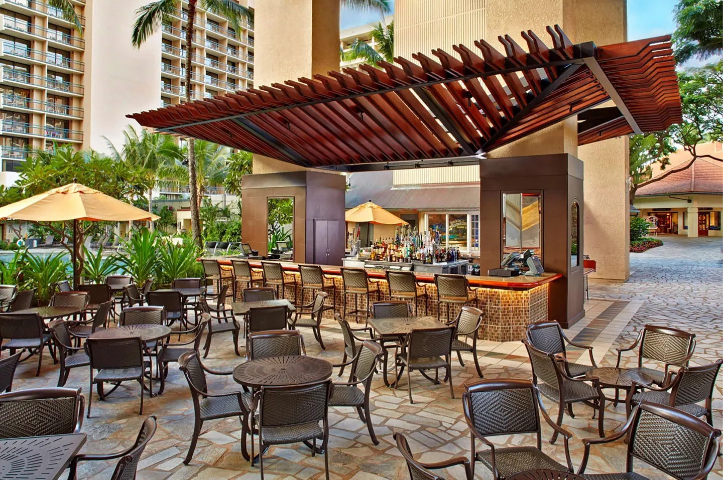 Open-air poolside bar seating at Hilton Hawaiian Village Waikiki Beach Resort.