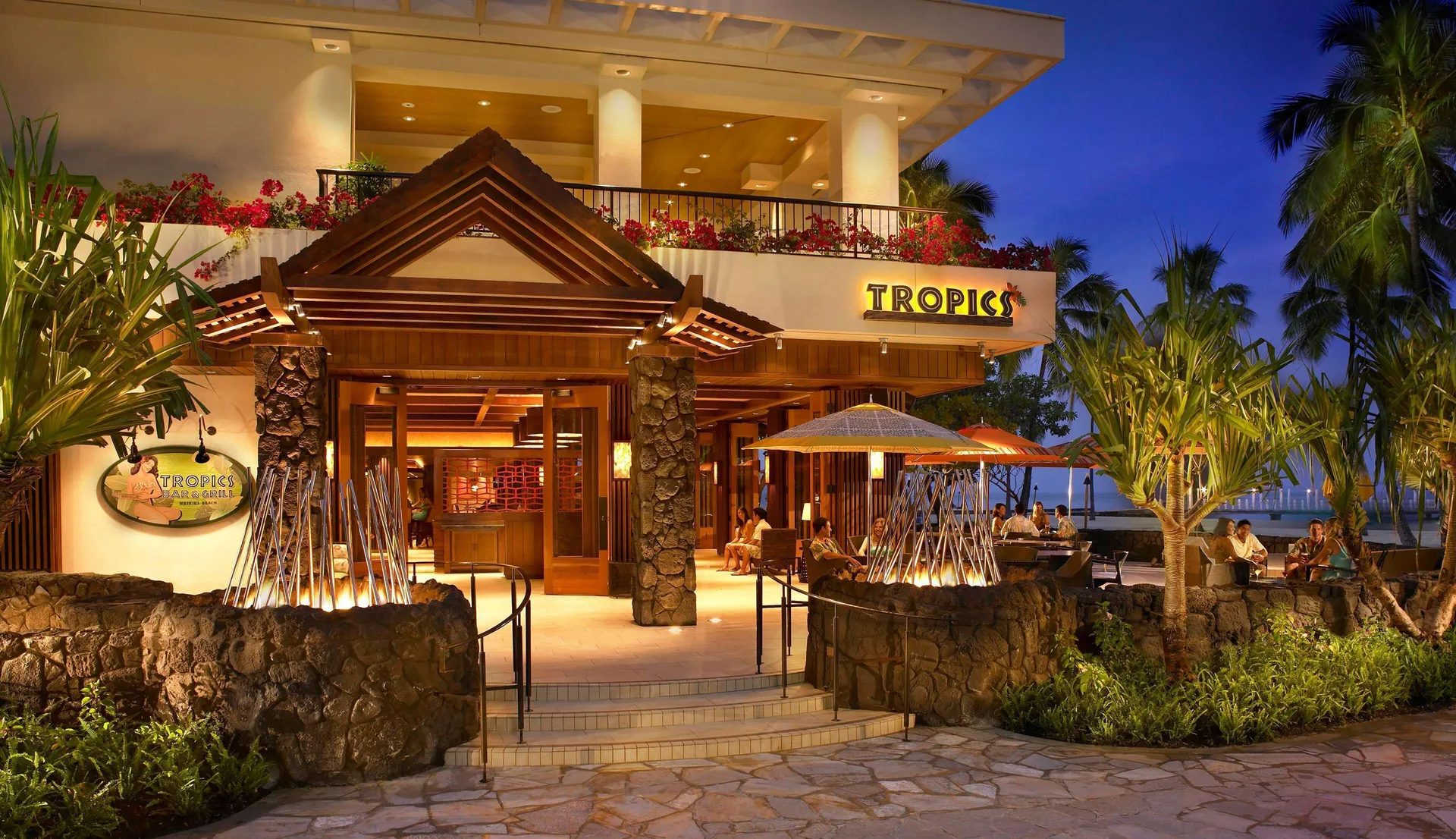 Tropics entrance and outdoor seating at Hilton Hawaiian Village Waikiki Beach Resort.