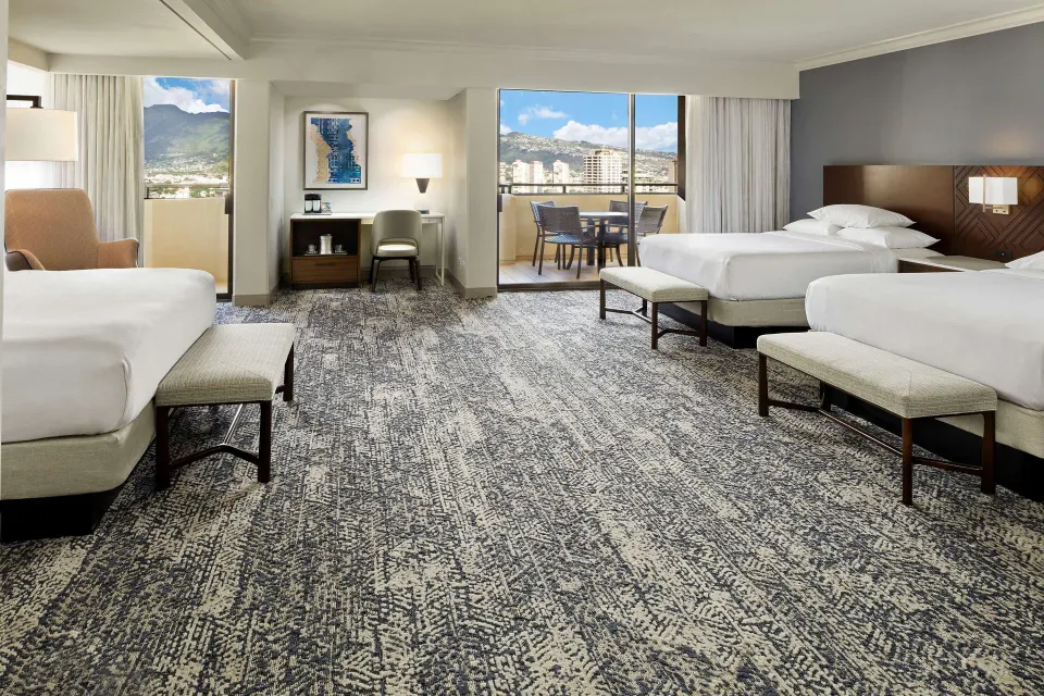 Spacious Family Room with multiple beds at Hilton Hawaiian Village Waikiki Beach Resort.