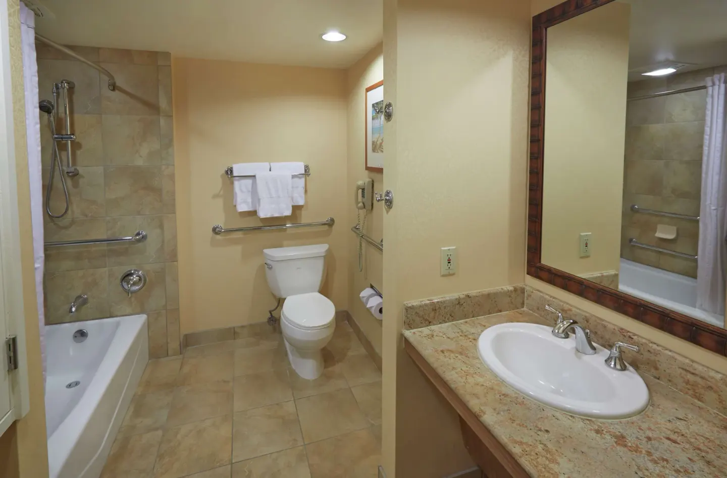 Accessible bathtub and bathroom vanity in a guest room at Hilton Hawaiian Village Waikiki Beach Resort.