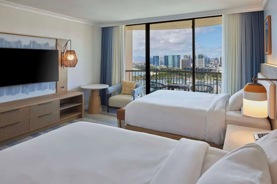 Accessible Ocean View room with two beds and balcony seating at Hilton Hawaiian Village Waikiki Beach Resort.