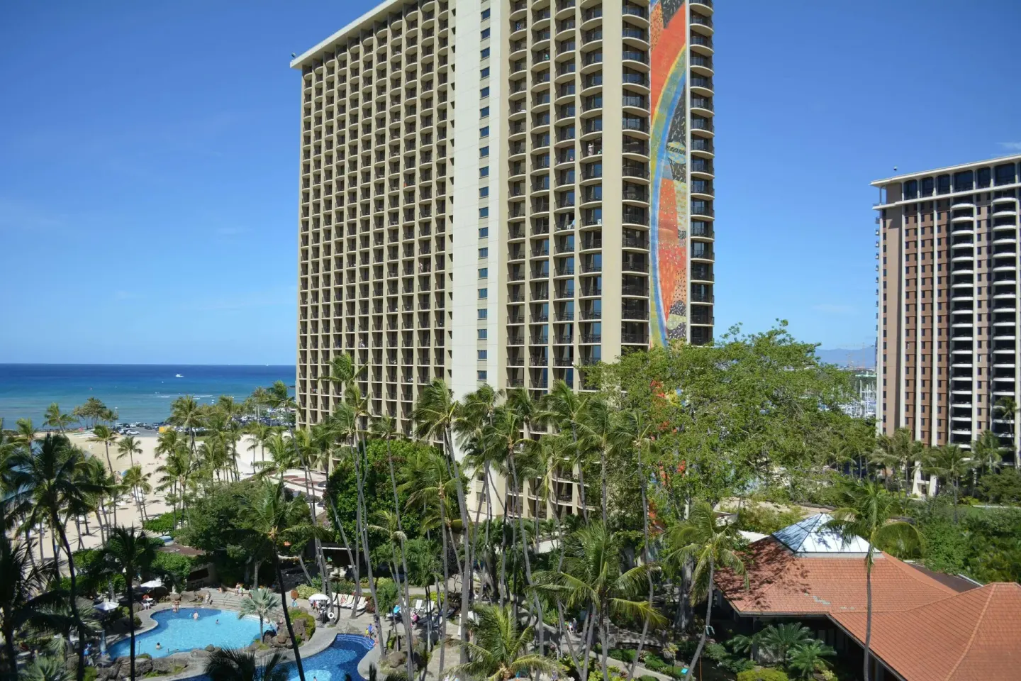 Ocean view from an accessible room at Hilton Hawaiian Village Waikiki Beach Resort with towers and pool.