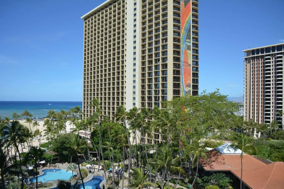 Ocean view from an accessible room at Hilton Hawaiian Village Waikiki Beach Resort with towers and pool.