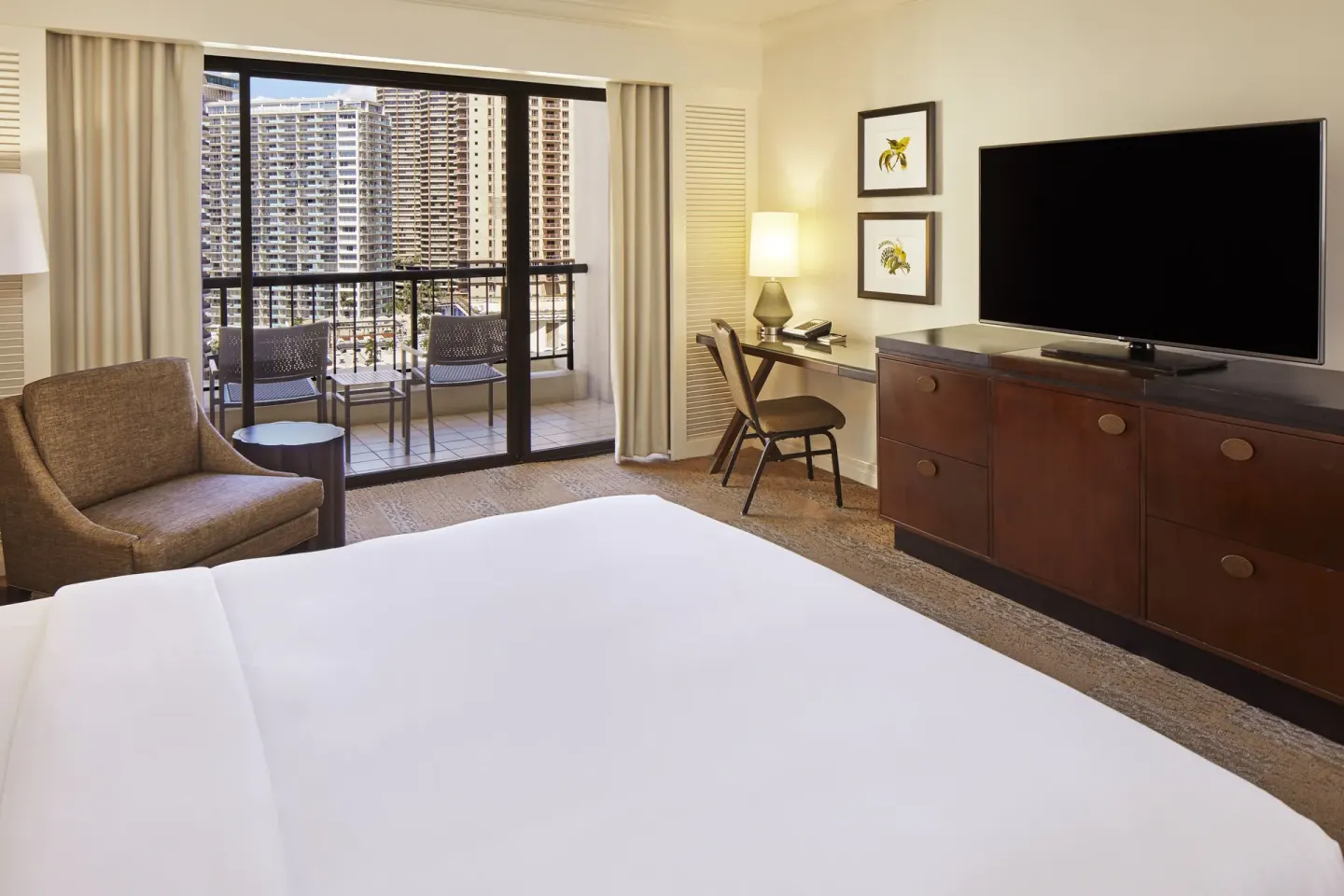 Accessible guest room with king bed, balcony, desk, and TV at Hilton Hawaiian Village Waikiki Beach Resort.