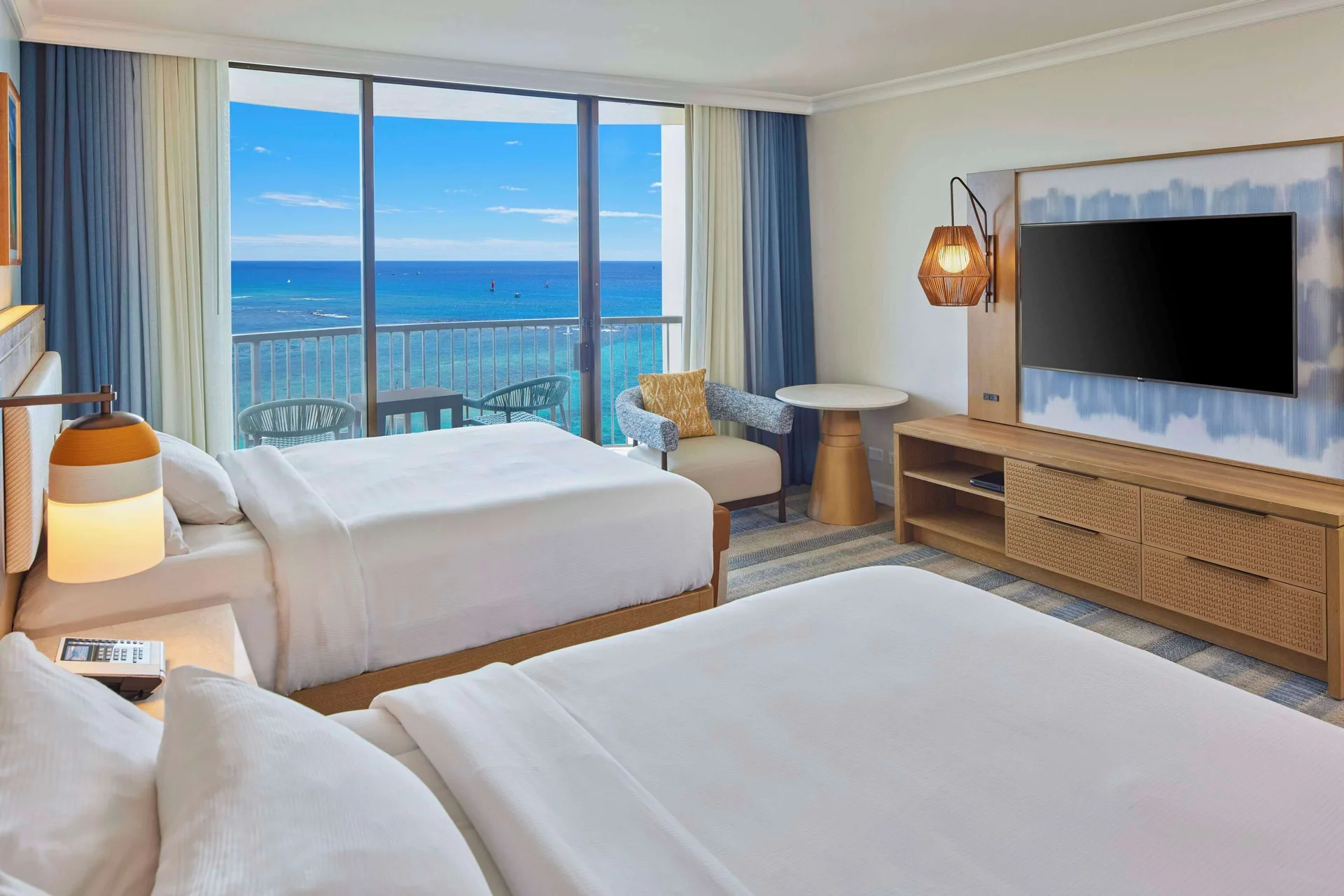 Two-bed Rainbow Tower guest room with ocean balcony at Hilton Hawaiian Village Waikiki Beach Resort.