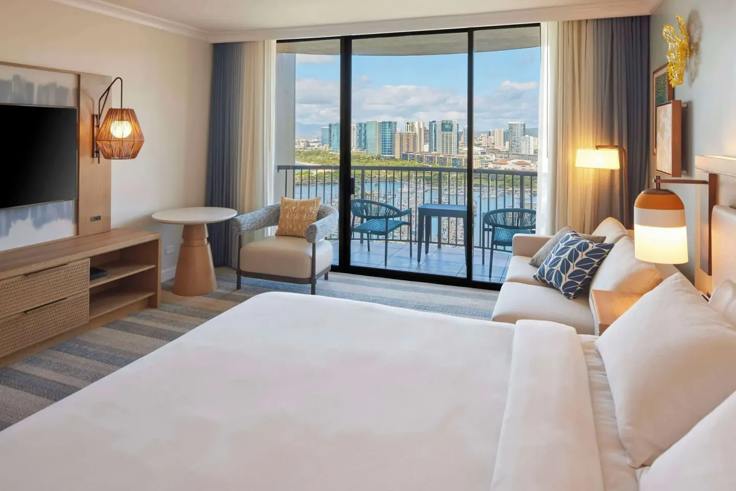 King ocean view room at Hilton Hawaiian Village Waikiki Beach Resort with balcony overlooking marina and skyline.