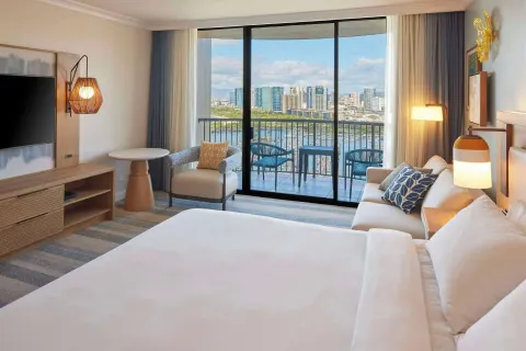 King ocean view room at Hilton Hawaiian Village Waikiki Beach Resort with balcony overlooking marina and skyline.