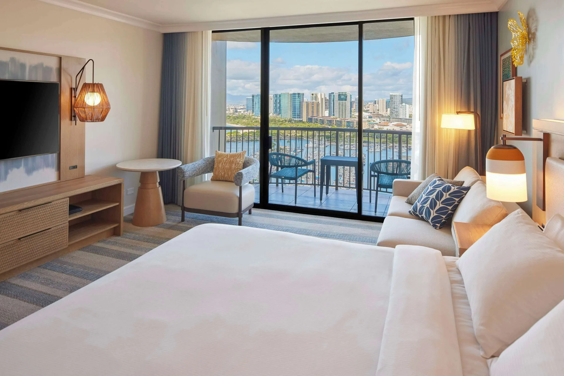 King ocean view room at Hilton Hawaiian Village Waikiki Beach Resort with balcony overlooking marina and skyline.