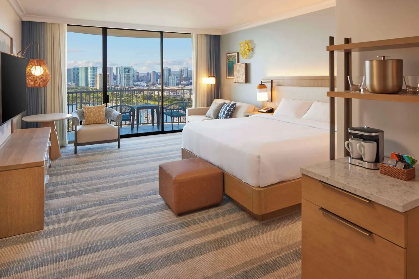 King ocean view room at Hilton Hawaiian Village Waikiki Beach Resort with sofa, balcony, and city view.