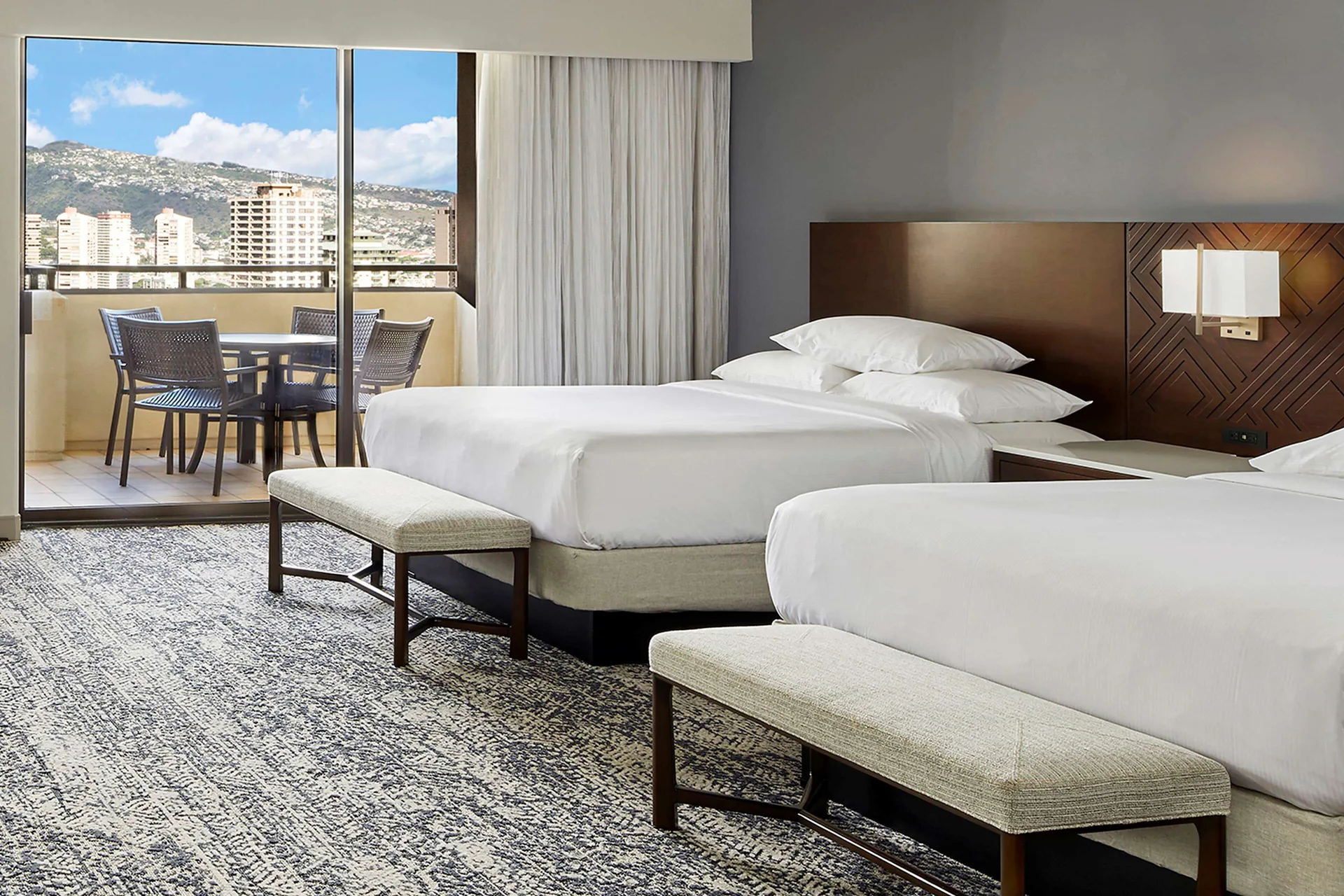 Two-bed ocean view guest room with balcony at Hilton Hawaiian Village Waikiki Beach Resort.