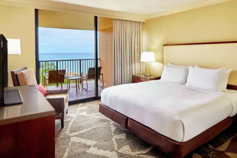 King Ocean View room with balcony chairs at Hilton Hawaiian Village Waikiki Beach Resort.