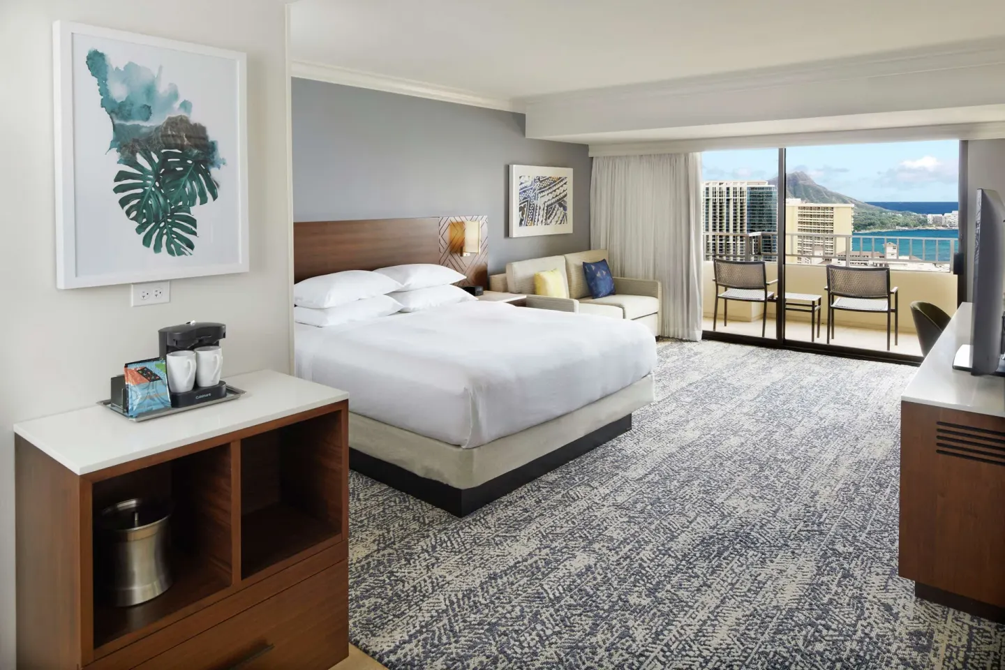 Partial Ocean View room with king bed and balcony at Hilton Hawaiian Village Waikiki Beach Resort.