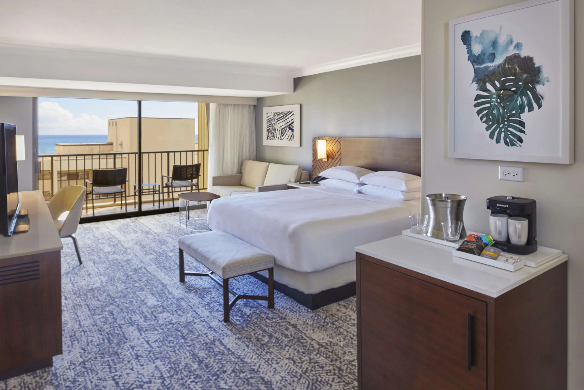 Resort View Tapa Collection guest room with king bed and balcony at Hilton Hawaiian Village Waikiki Beach Resort.
