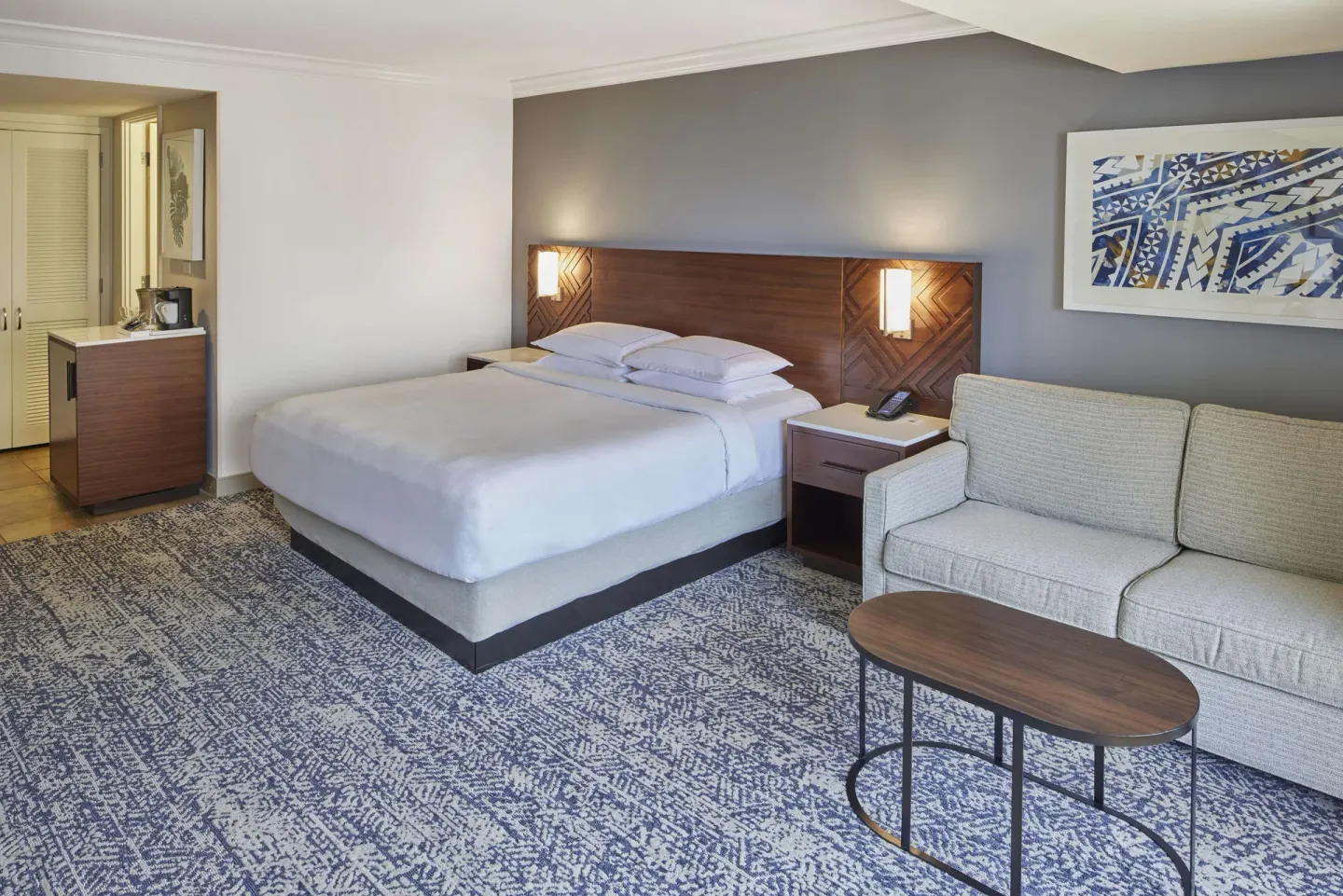 King-bed room with sofa seating at Hilton Hawaiian Village Waikiki Beach Resort.